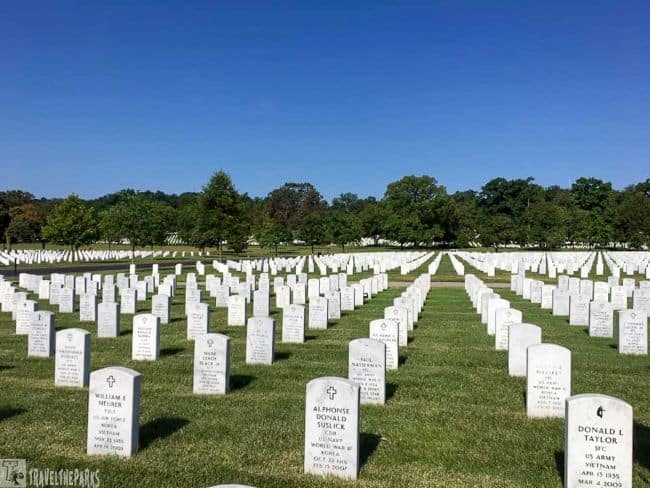 Arlington National Cemetery Military cemetery with rows of white headstones under a clear blue sky.