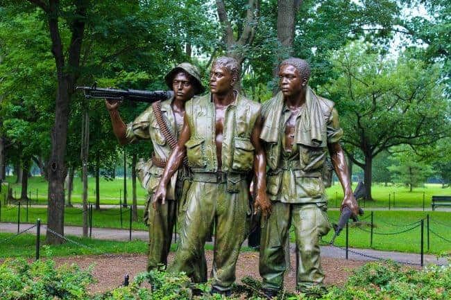Bronze statue of three soldiers in a park, part of a Vietnam war memorial.