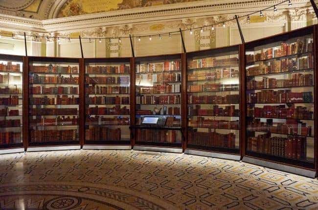 Library of Congress-Library with curved glass bookcases filled with books and decorative lighting.