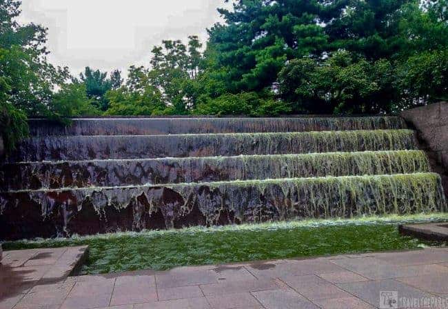 Franklin Delano Roosevelt Memorial multi-tiered waterfall with lush greenery in the background.