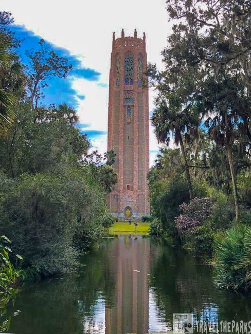Bok Tower rising above lush greenery and a reflective pond.