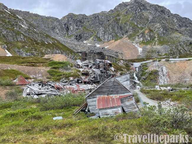 Abandoned buildings with rusted roofs in a mountainous landscape at the Independence Mine.