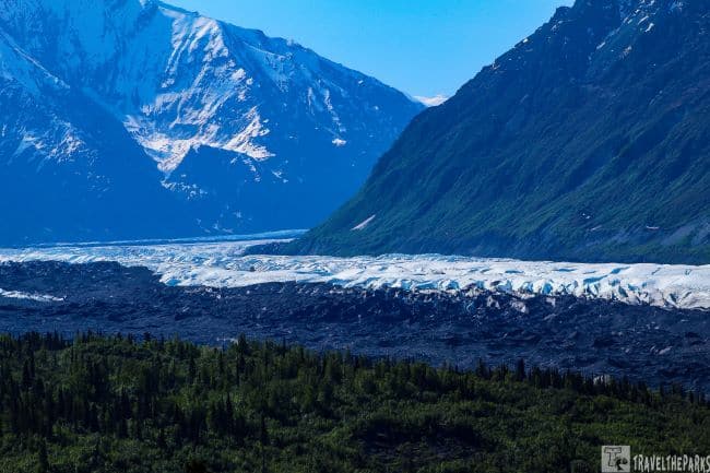 Lateral Moraine View of Matanuska Glacier with a forest in the foreground.