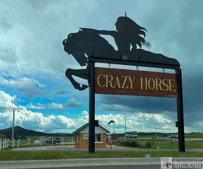 Entrance archway with a Native American on horseback silhouette and a "CRAZY HORSE" sign.