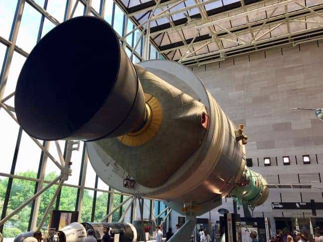 Rocket engine exhibit in a museum gallery with visitors.