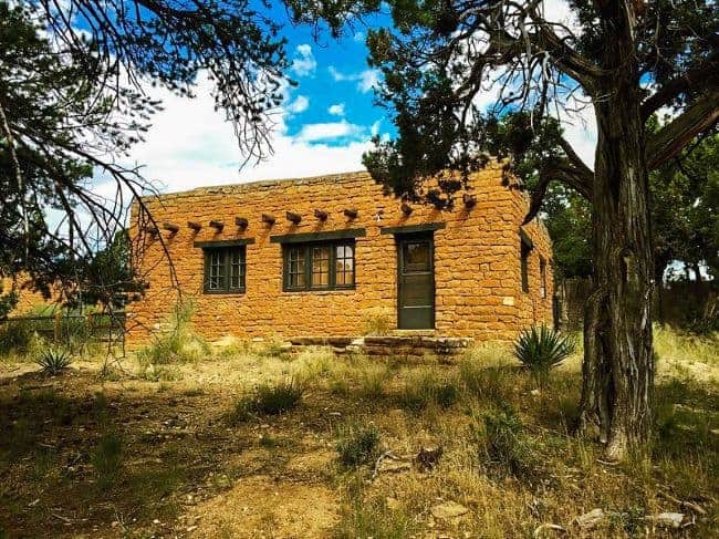 A brown adobe building the Chapin mesa archeological museum set in a desert landscape 